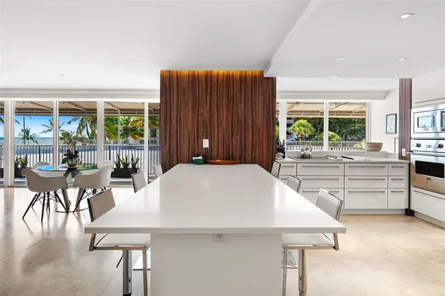 a kitchen with a table chairs and a window