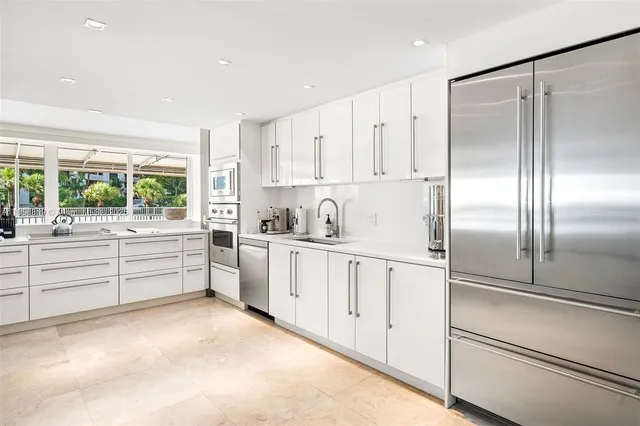 a kitchen with white cabinets and white appliances