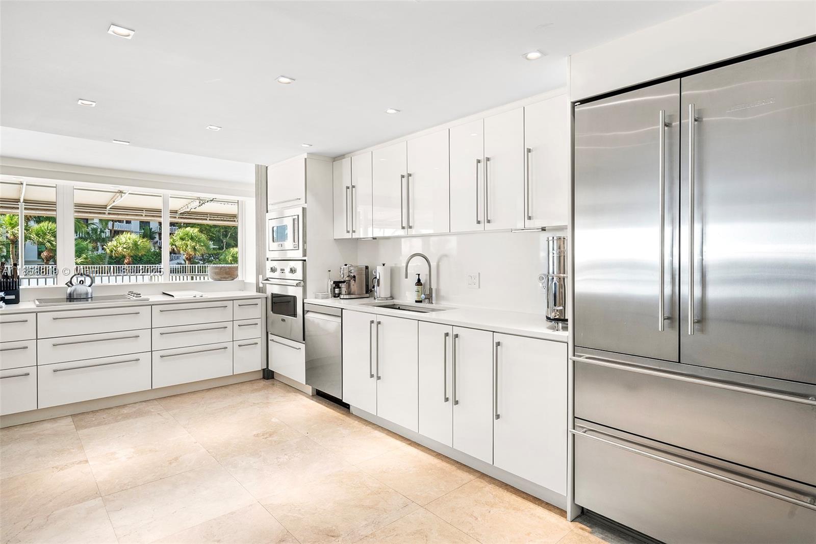 600 Grapetree Drive, Unit 3BS Key Biscayne, FL 33149 - Photo 14 of 47 a kitchen with white cabinets and white appliances