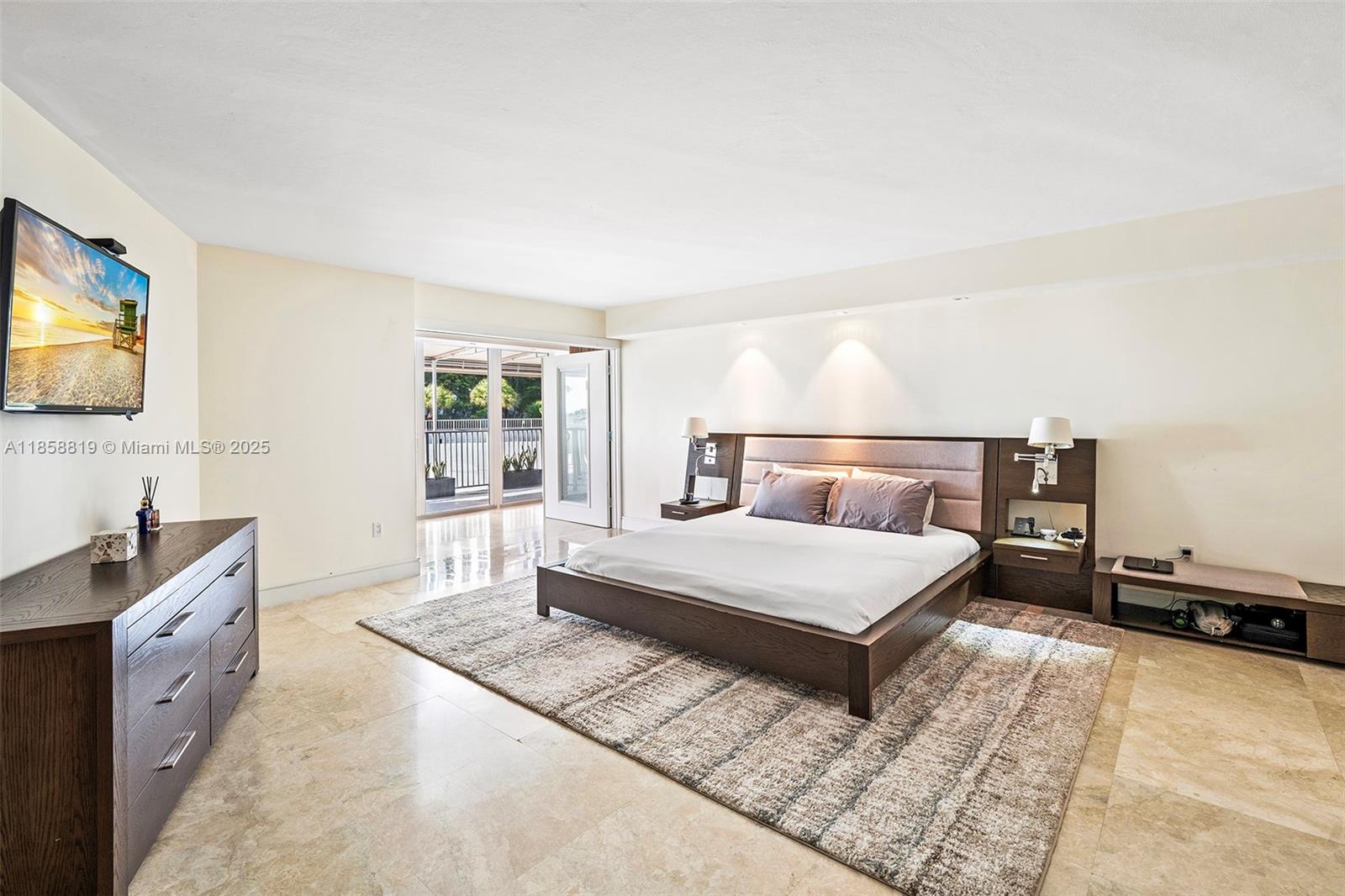 600 Grapetree Drive, Unit 3BS Key Biscayne, FL 33149 - Photo 15 of 47 a bedroom with a large bed and a flat tv screen on dresser