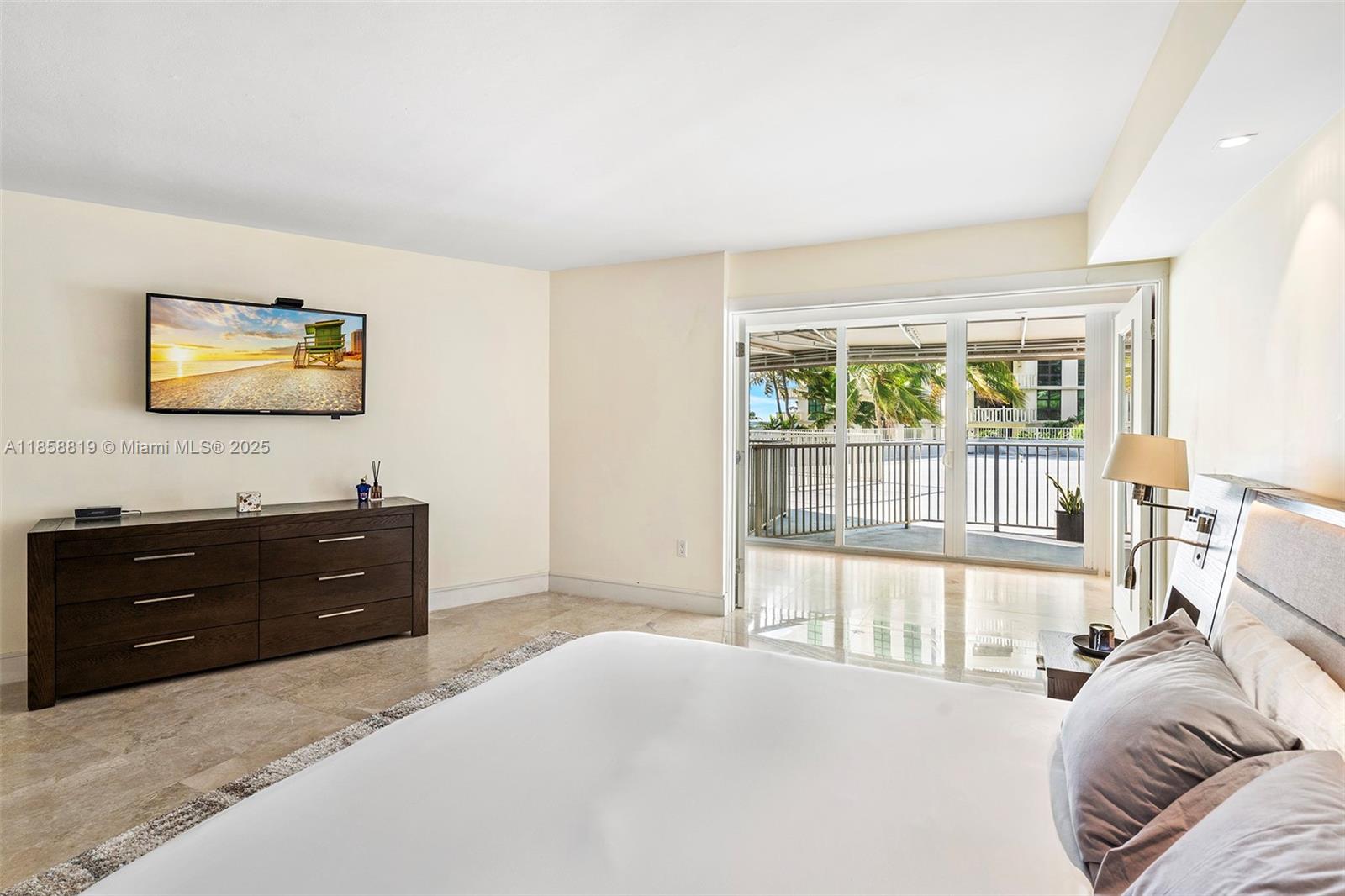 600 Grapetree Drive, Unit 3BS Key Biscayne, FL 33149 - Photo 18 of 47 a bedroom with a bed and a flat screen tv