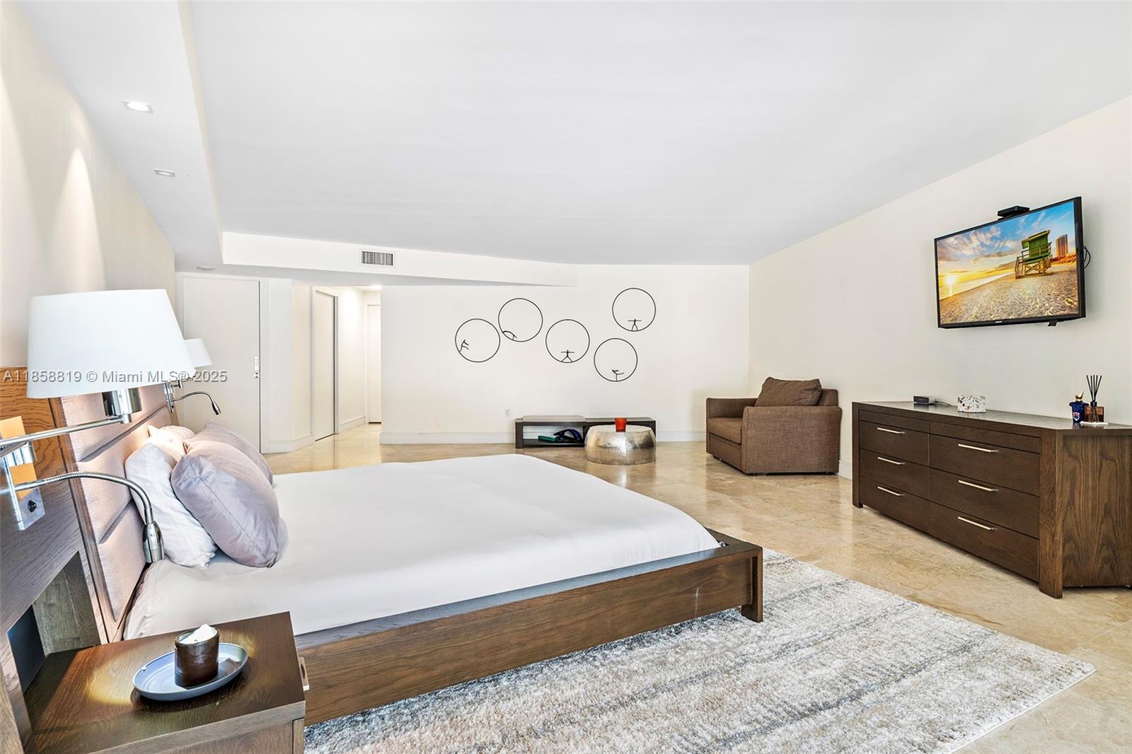 600 Grapetree Drive, Unit 3BS Key Biscayne, FL 33149 - Photo 19 of 47 a bedroom with a bed and cabinets