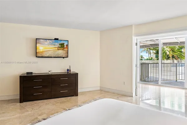 a room with a dresser and a flat screen tv