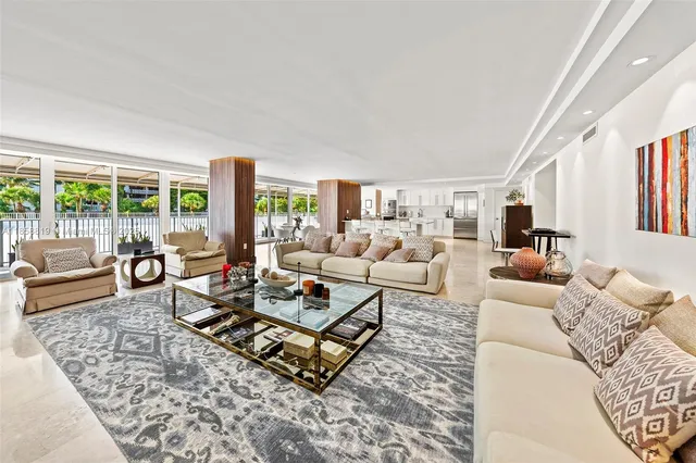 a living room with furniture a rug and a large window