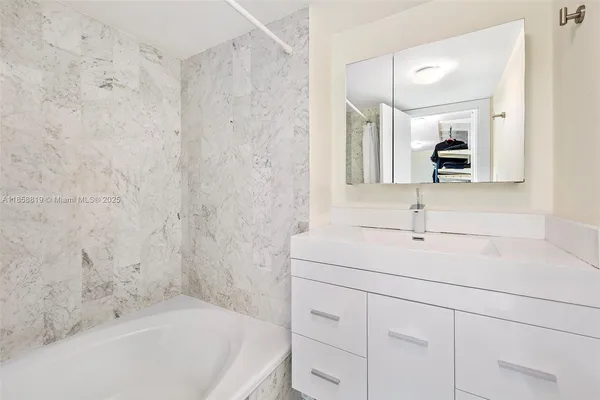a bathroom with a bathtub and a sink
