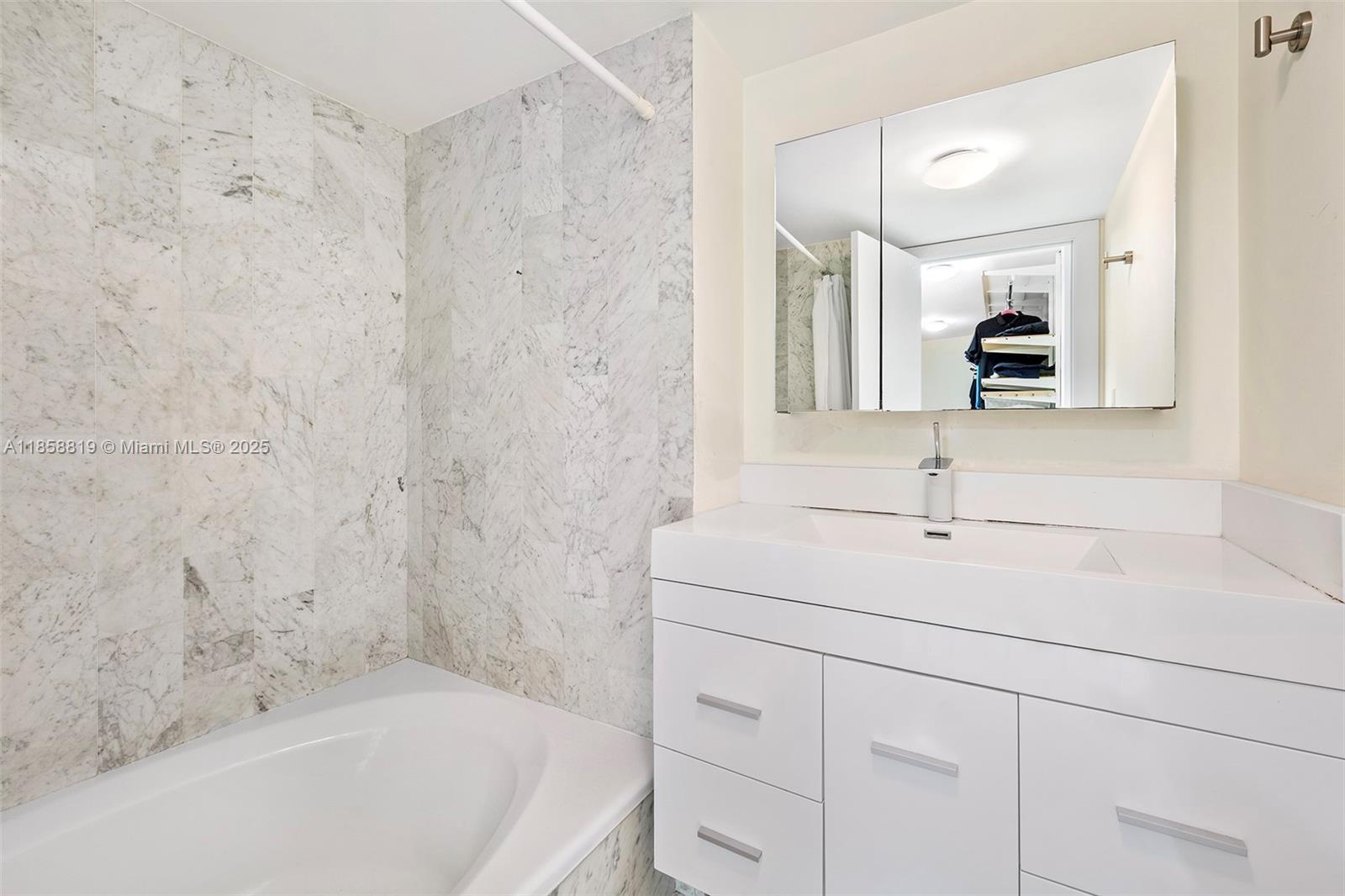 600 Grapetree Drive, Unit 3BS Key Biscayne, FL 33149 - Photo 23 of 47 a bathroom with a bathtub and a sink