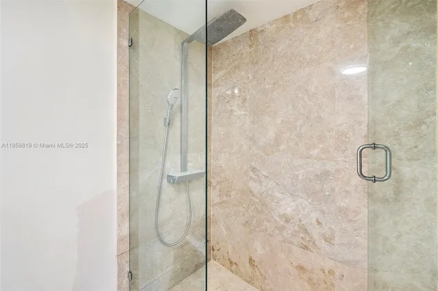 a bathroom with a glass shower door