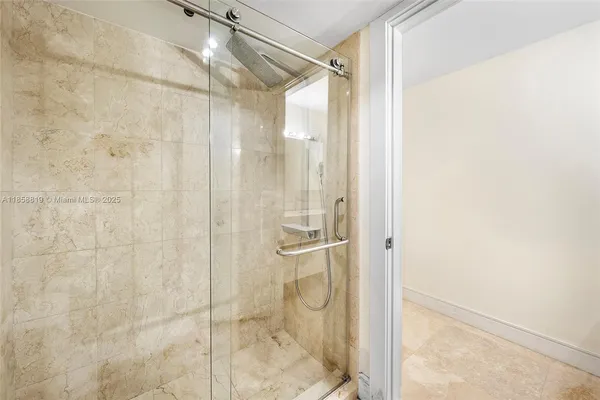 a bathroom with a glass shower door
