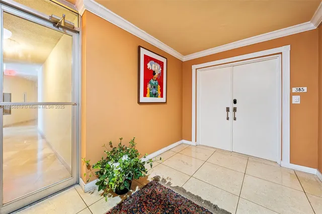 a view of a hallway with a flower pot and a large window