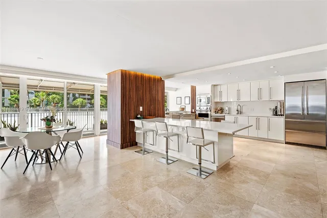 a living room with furniture a dining table and chairs with kitchen view