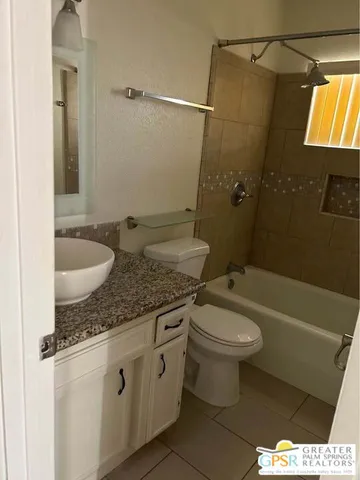 a white toilet sitting next to a shower