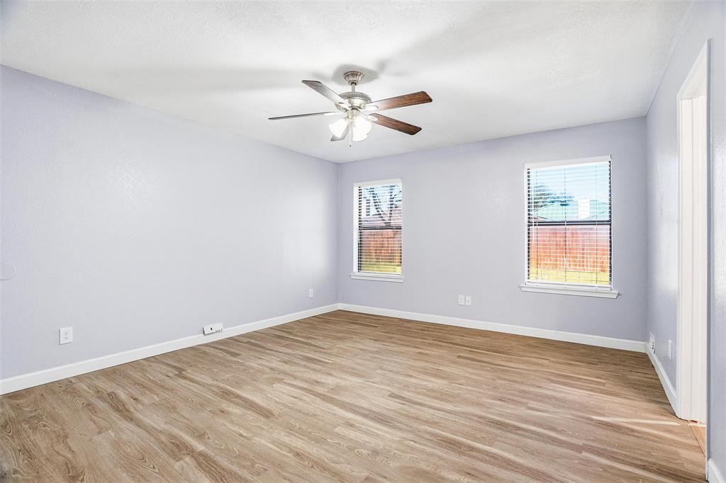 416 Colonial Place Everman, TX 76140 - Photo 14 of 39 wooden floor in an empty room with a window