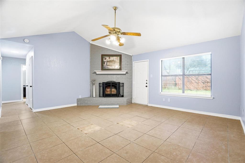 416 Colonial Place Everman, TX 76140 - Photo 17 of 39 an empty room with windows and fireplace