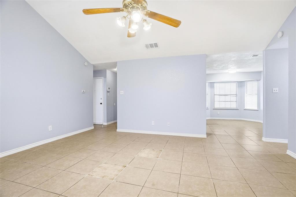 416 Colonial Place Everman, TX 76140 - Photo 19 of 39 an empty room with a ceiling fan and glass door