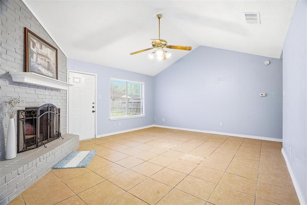416 Colonial Place Everman, TX 76140 - Photo 21 of 39 a view of an empty room with a fireplace and a window