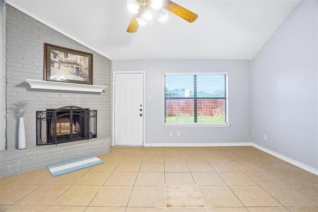 416 Colonial Place Everman, TX 76140 - Photo 22 of 39 an empty room with windows and fireplace