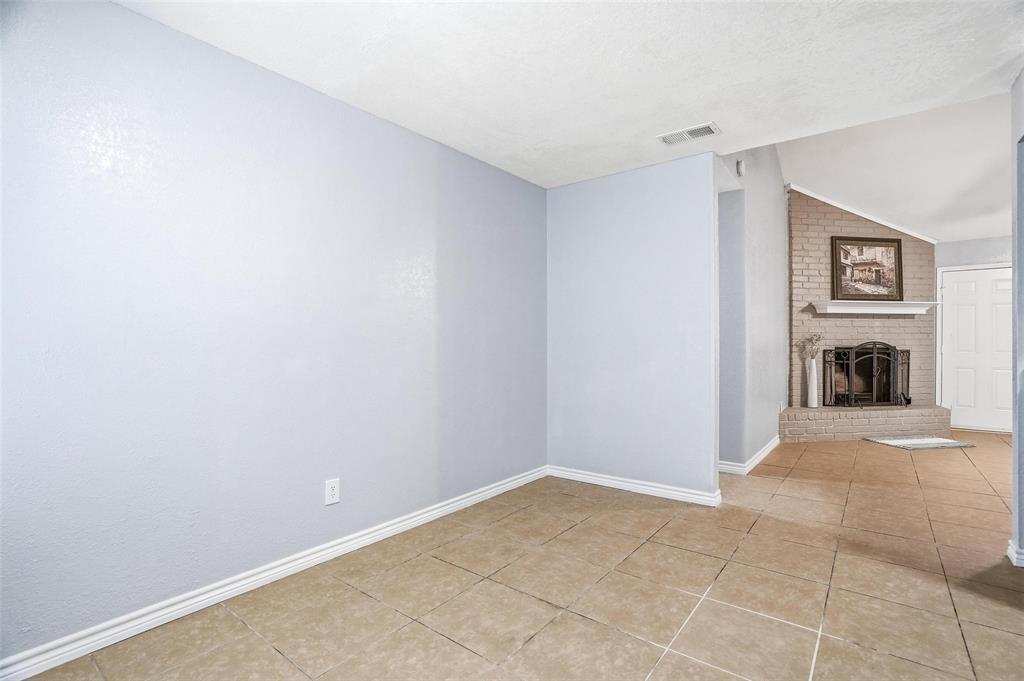 416 Colonial Place Everman, TX 76140 - Photo 23 of 39 a view of a livingroom with wooden floor and a fireplace