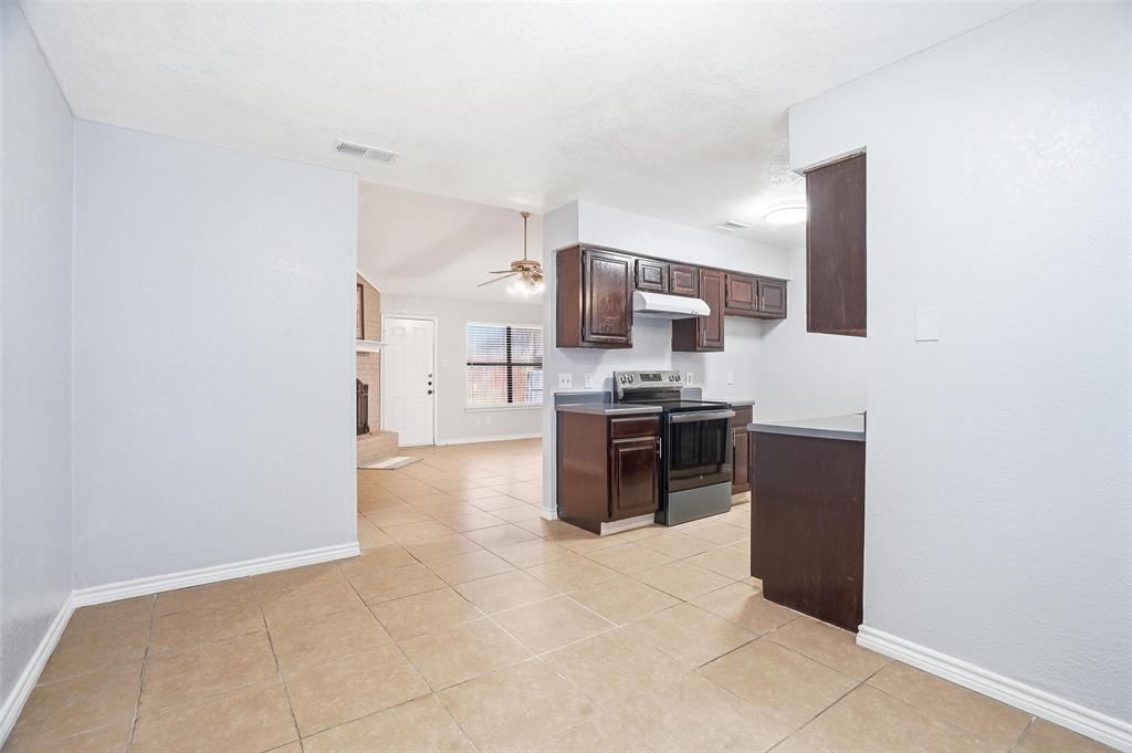 416 Colonial Place Everman, TX 76140 - Photo 24 of 39 a kitchen with stainless steel appliances a refrigerator and a stove top oven