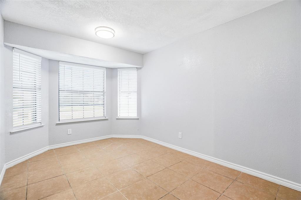 416 Colonial Place Everman, TX 76140 - Photo 26 of 39 an empty room with a empty space and windows
