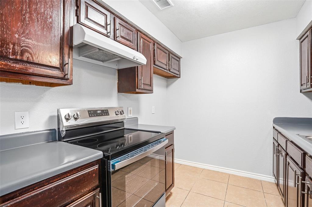 416 Colonial Place Everman, TX 76140 - Photo 28 of 39 a stove top oven sitting inside of a kitchen