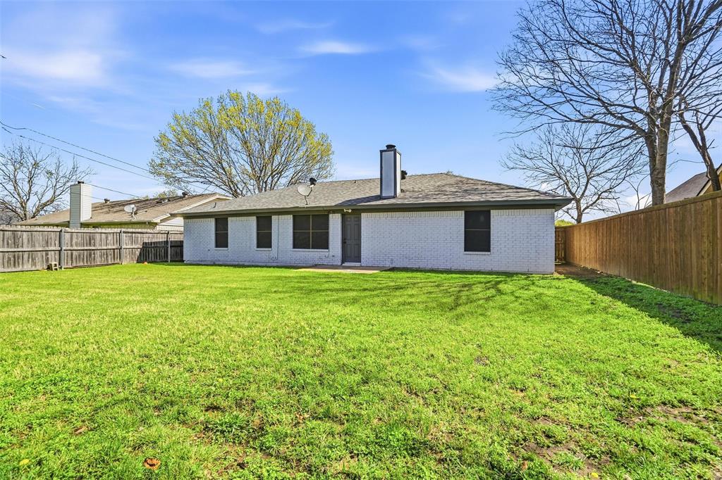 416 Colonial Place Everman, TX 76140 - Photo 34 of 39 a front view of a house with garden