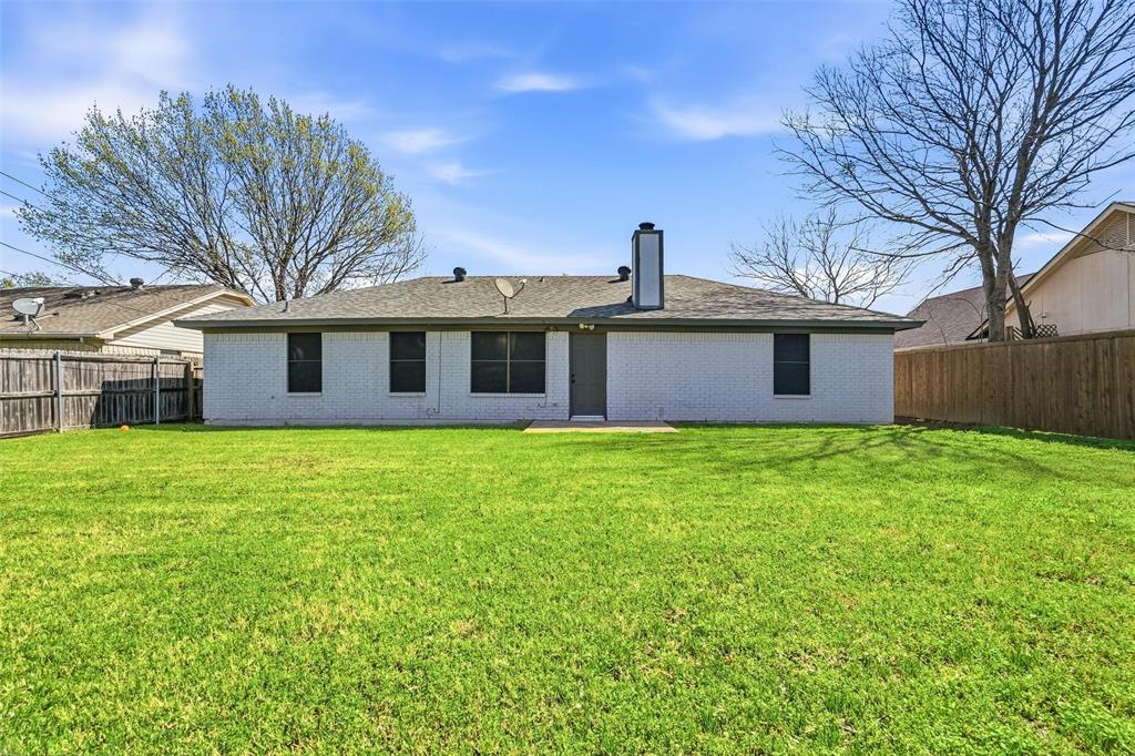 416 Colonial Place Everman, TX 76140 - Photo 35 of 39 a front view of a house with a garden