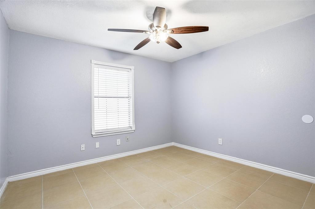416 Colonial Place Everman, TX 76140 - Photo 4 of 39 an empty room with windows and ceiling fan