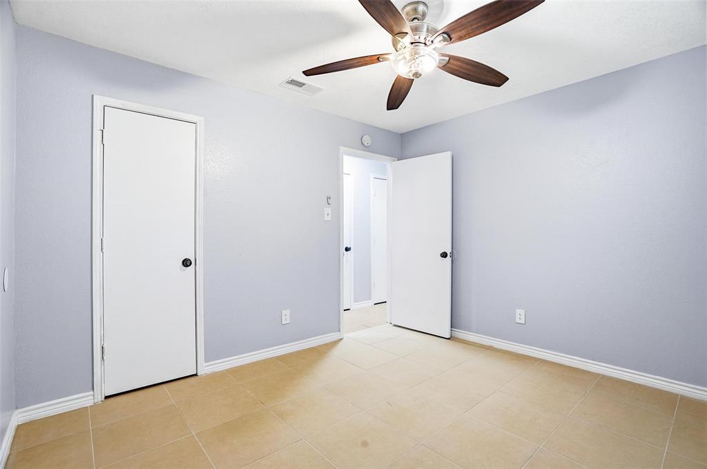 416 Colonial Place Everman, TX 76140 - Photo 5 of 39 an empty room with closet and a chandelier fan