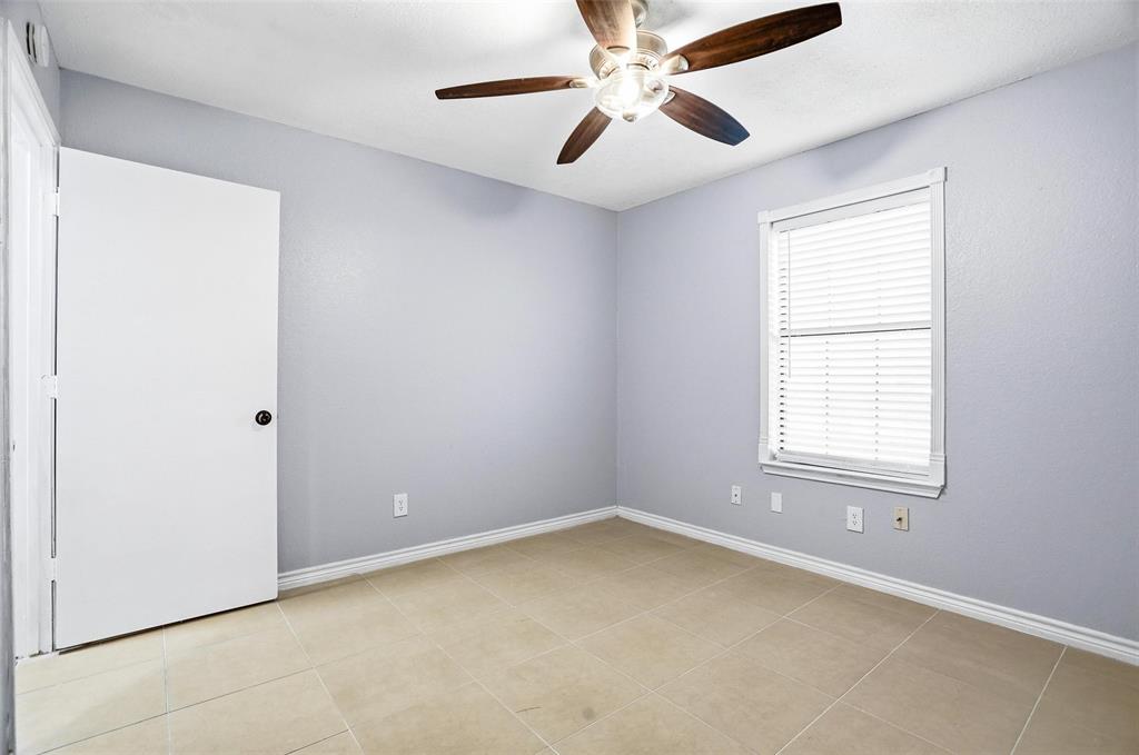 416 Colonial Place Everman, TX 76140 - Photo 6 of 39 an empty room with a window and a fan