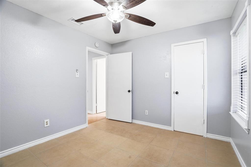 416 Colonial Place Everman, TX 76140 - Photo 9 of 39 an empty room with chandelier fan and windows