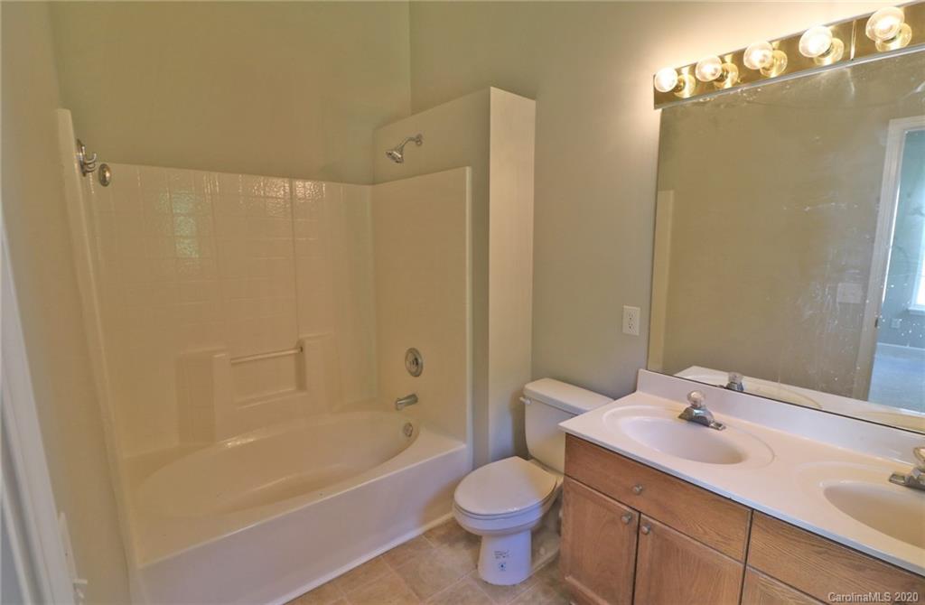 1911 Decatur Court Charlotte, NC 28213 - Photo 13 of 16 a bathroom with a sink a toilet and shower