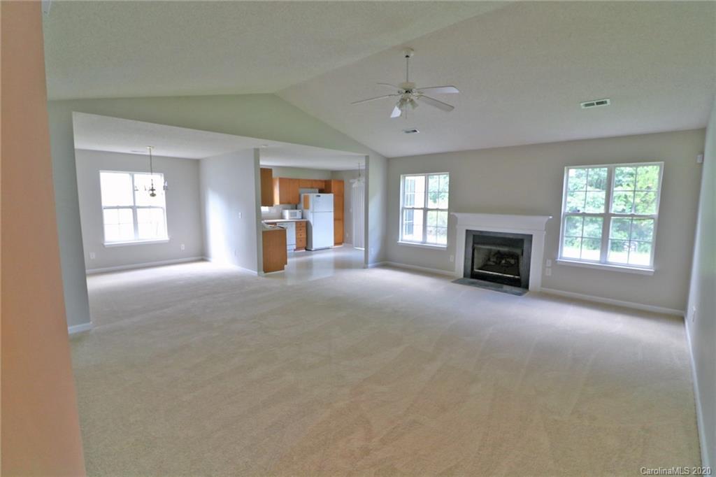 1911 Decatur Court Charlotte, NC 28213 - Photo 3 of 16 an empty room with windows fireplace and windows
