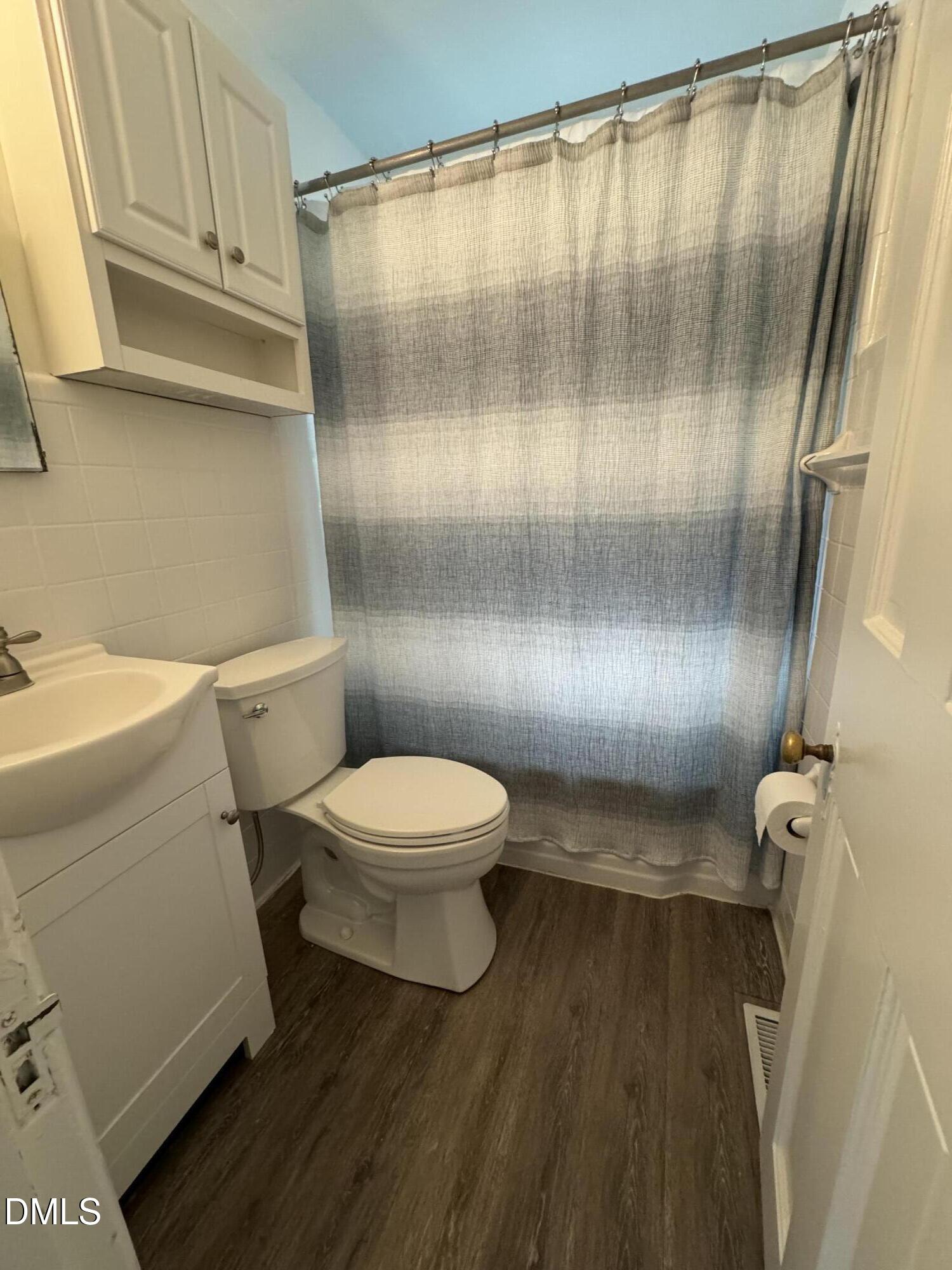 1009 Canterbury Road Raleigh, NC 27607 - Photo 26 of 31 a bathroom with a toilet and a shower