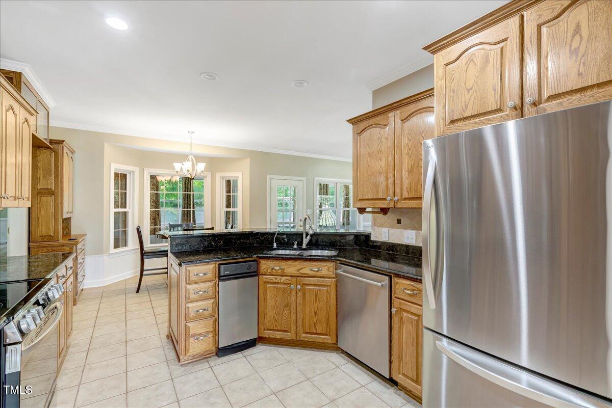 1086 Roberts Chapel Road Stem, NC 27581 - Photo 15 of 33 a kitchen with white cabinets and appliances