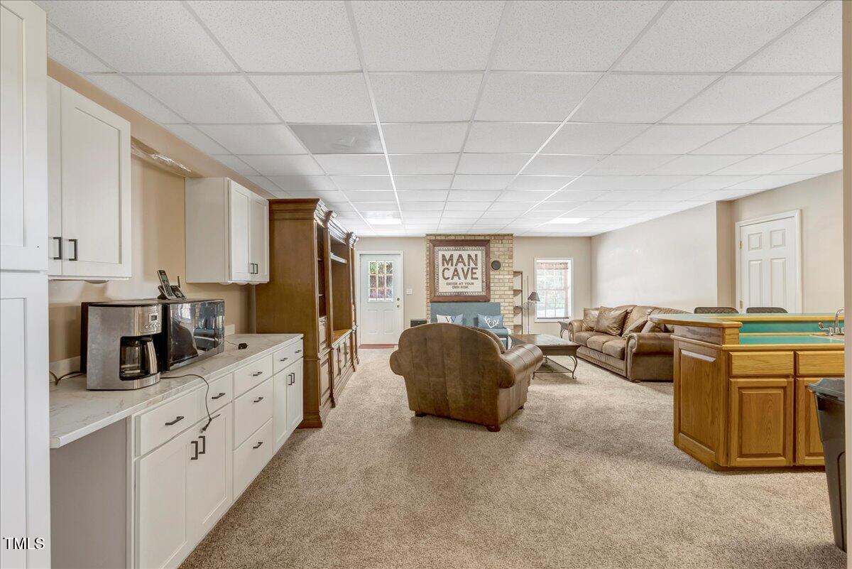 1086 Roberts Chapel Road Stem, NC 27581 - Photo 19 of 33 a living room with furniture and a flat screen tv