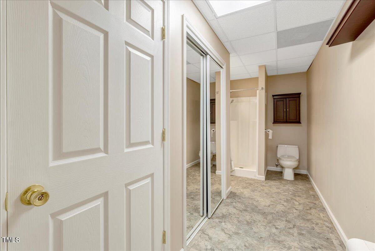 1086 Roberts Chapel Road Stem, NC 27581 - Photo 20 of 33 a view of a hallway with bathroom and wooden floor