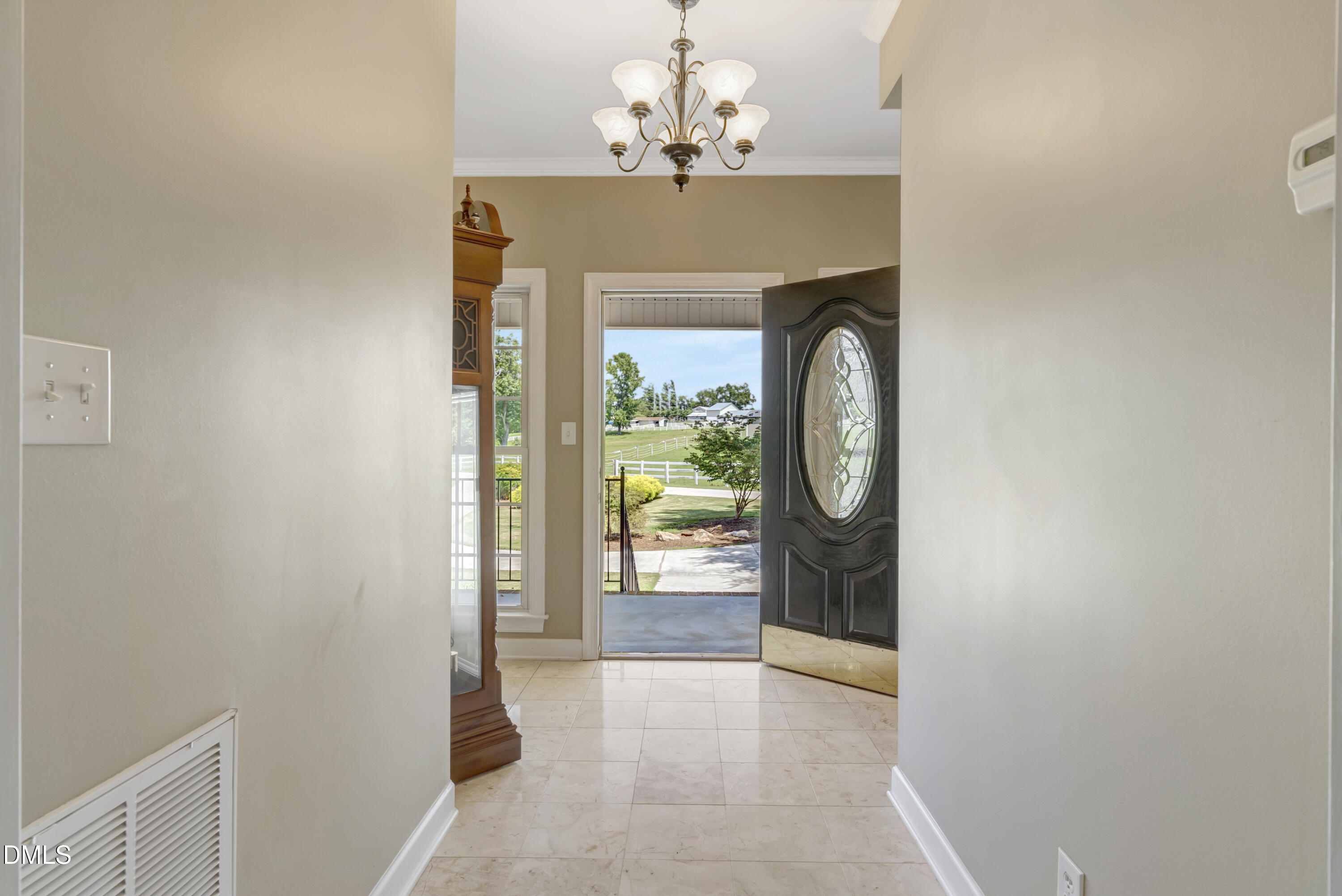 1086 Roberts Chapel Road Stem, NC 27581 - Photo 22 of 33 a view of a hallway with wooden floor and a chandelier