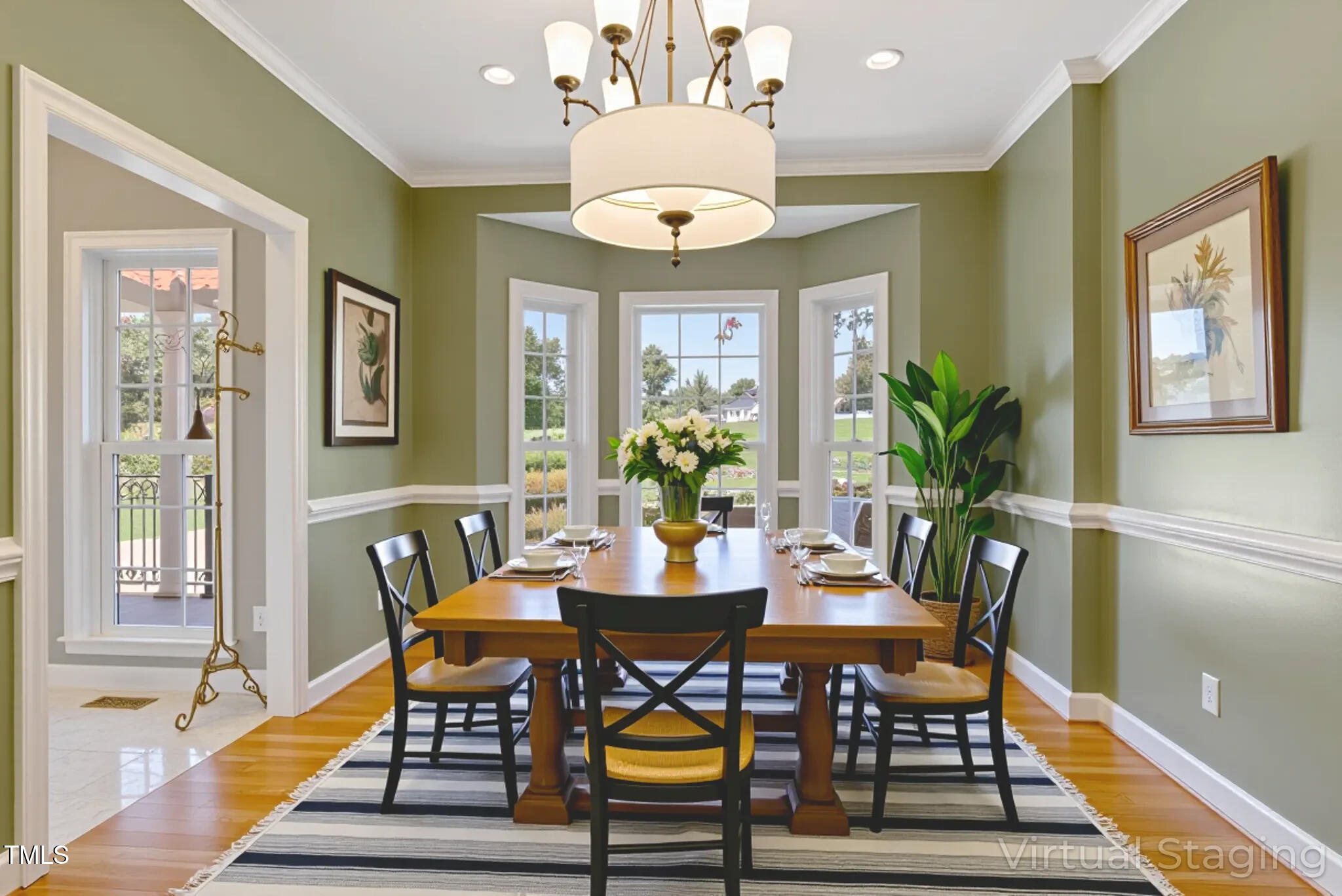 1086 Roberts Chapel Road Stem, NC 27581 - Photo 6 of 33 a dining room with wooden floor a chandelier a wooden table and chairs