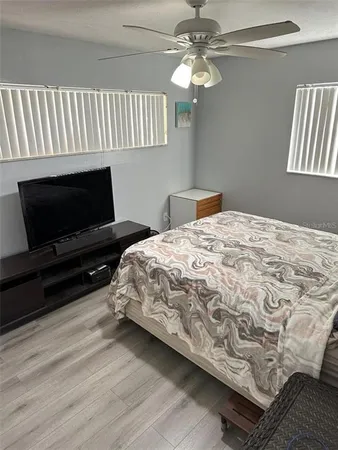 a bedroom with a bed and a flat screen tv