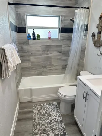 a bathroom with a toilet and a tub