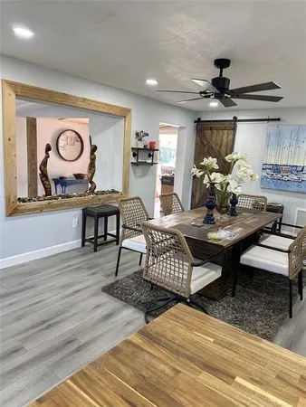 a view of a dining room with furniture window and wooden floor