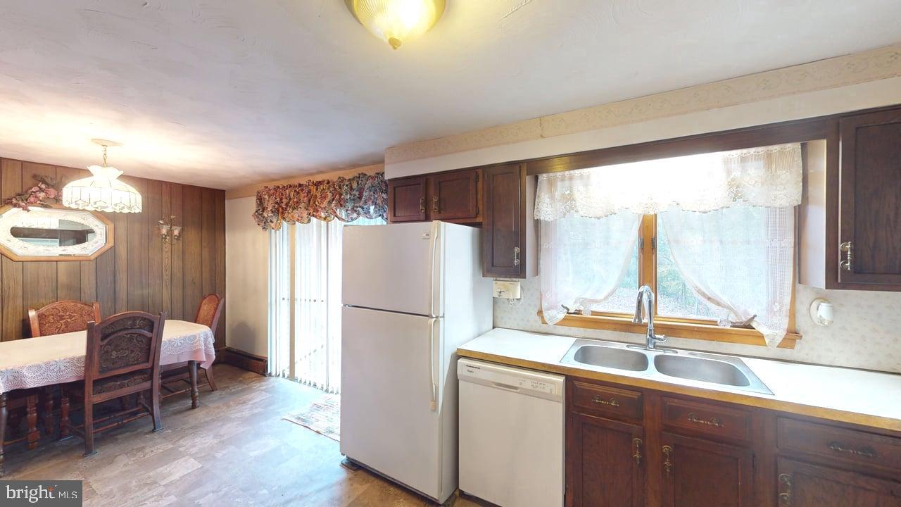 4549 Georges Run Road Ridgeley, WV 26753 - Photo 11 of 48 a kitchen with a refrigerator a sink and a dining table