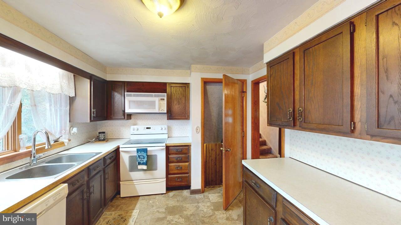 4549 Georges Run Road Ridgeley, WV 26753 - Photo 14 of 48 a kitchen with a sink stove and cabinets