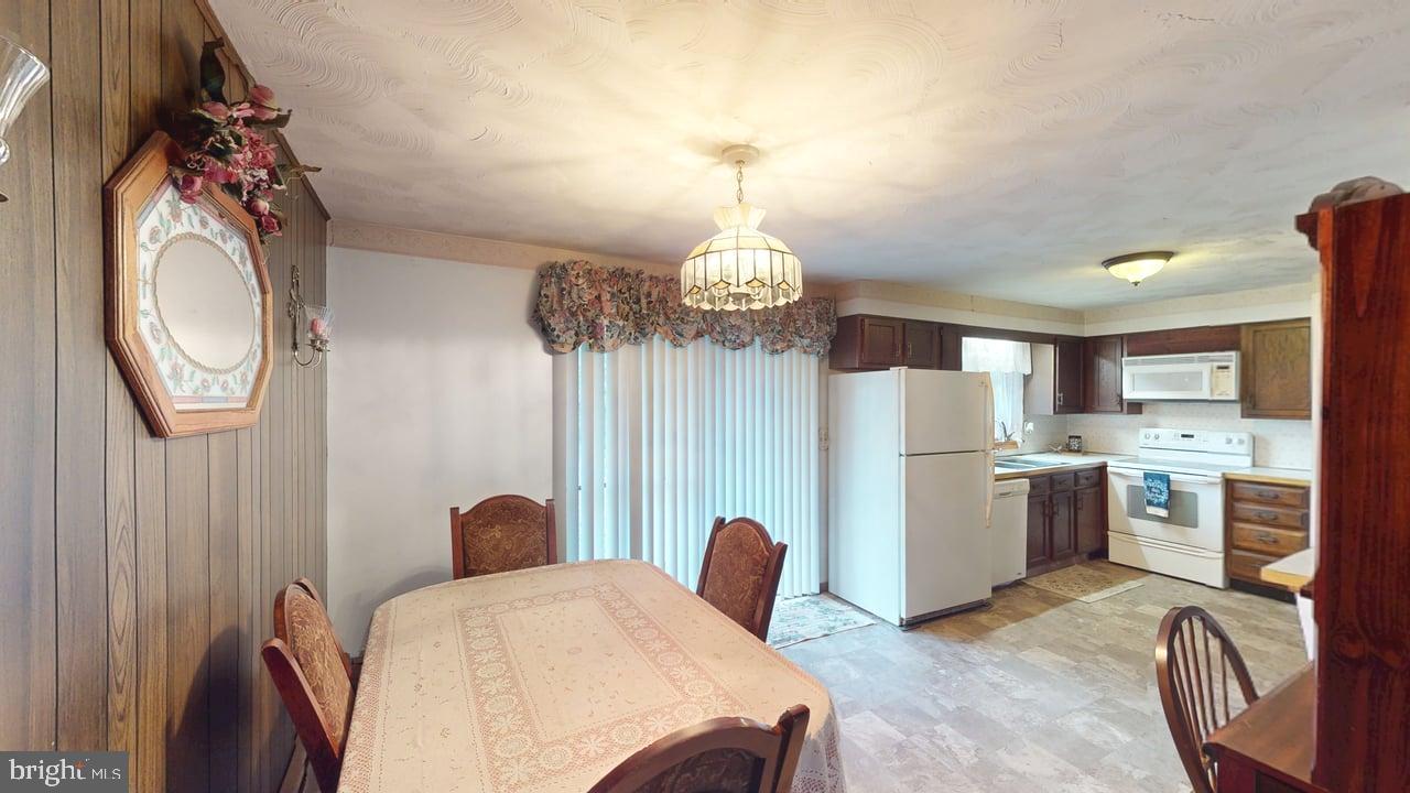 4549 Georges Run Road Ridgeley, WV 26753 - Photo 16 of 48 a view of a dining room with furniture and a chandelier