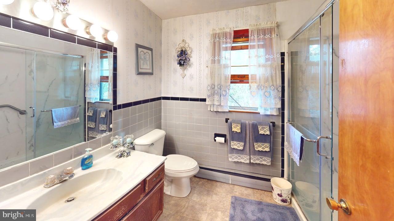 4549 Georges Run Road Ridgeley, WV 26753 - Photo 21 of 48 a bathroom with a sink toilet and shower