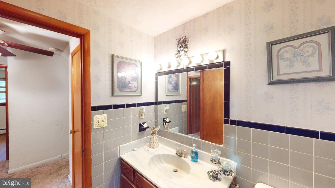 4549 Georges Run Road Ridgeley, WV 26753 - Photo 22 of 48 a bathroom with a sink mirror and shower