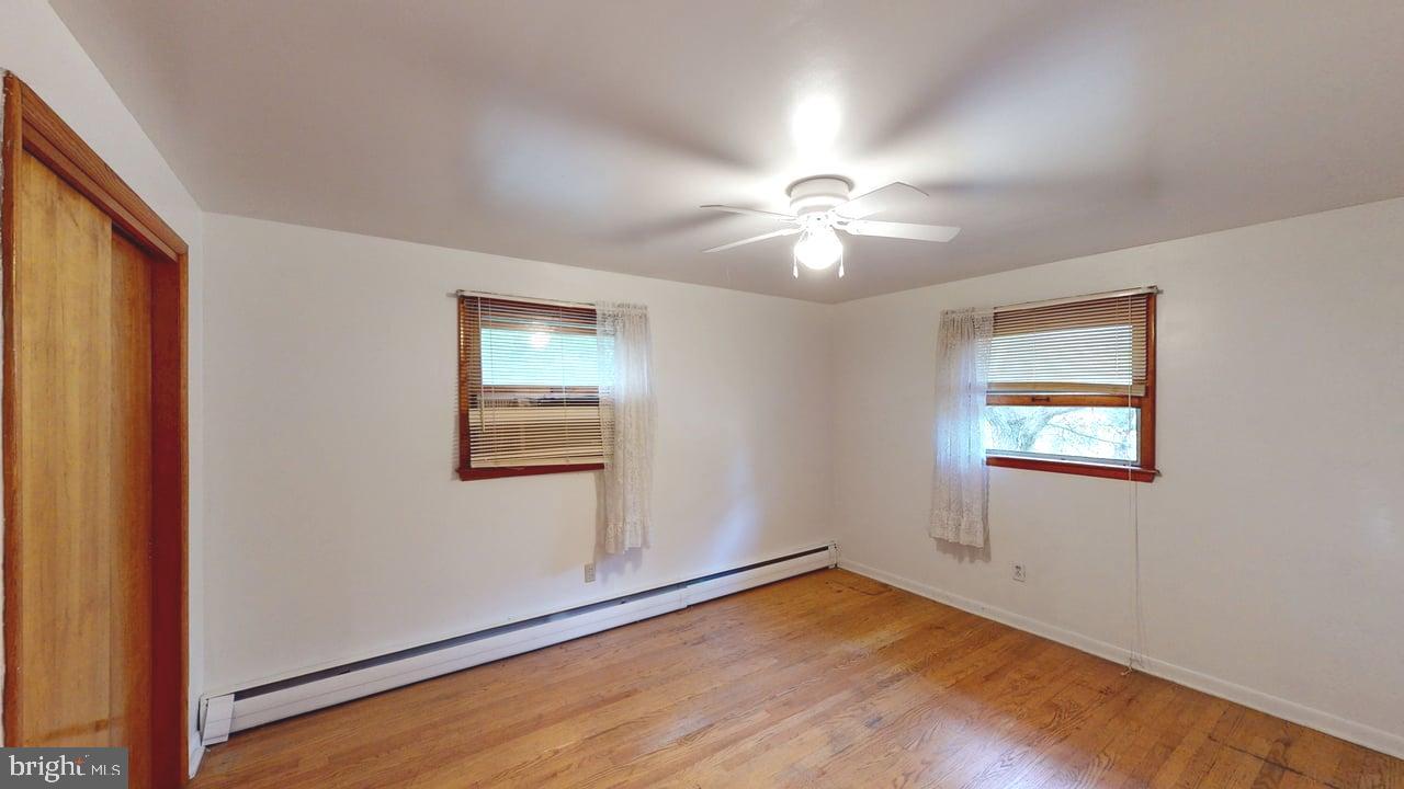 4549 Georges Run Road Ridgeley, WV 26753 - Photo 29 of 48 an empty room with windows and fan