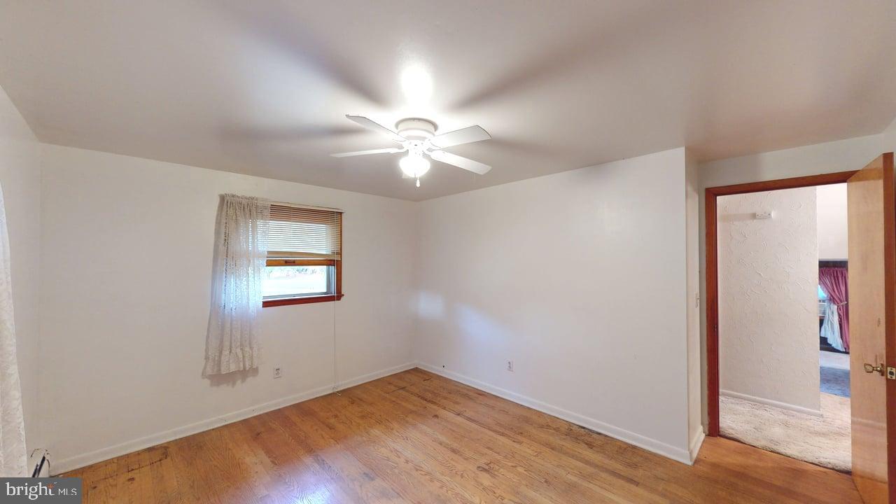 4549 Georges Run Road Ridgeley, WV 26753 - Photo 30 of 48 an empty room with windows and fan