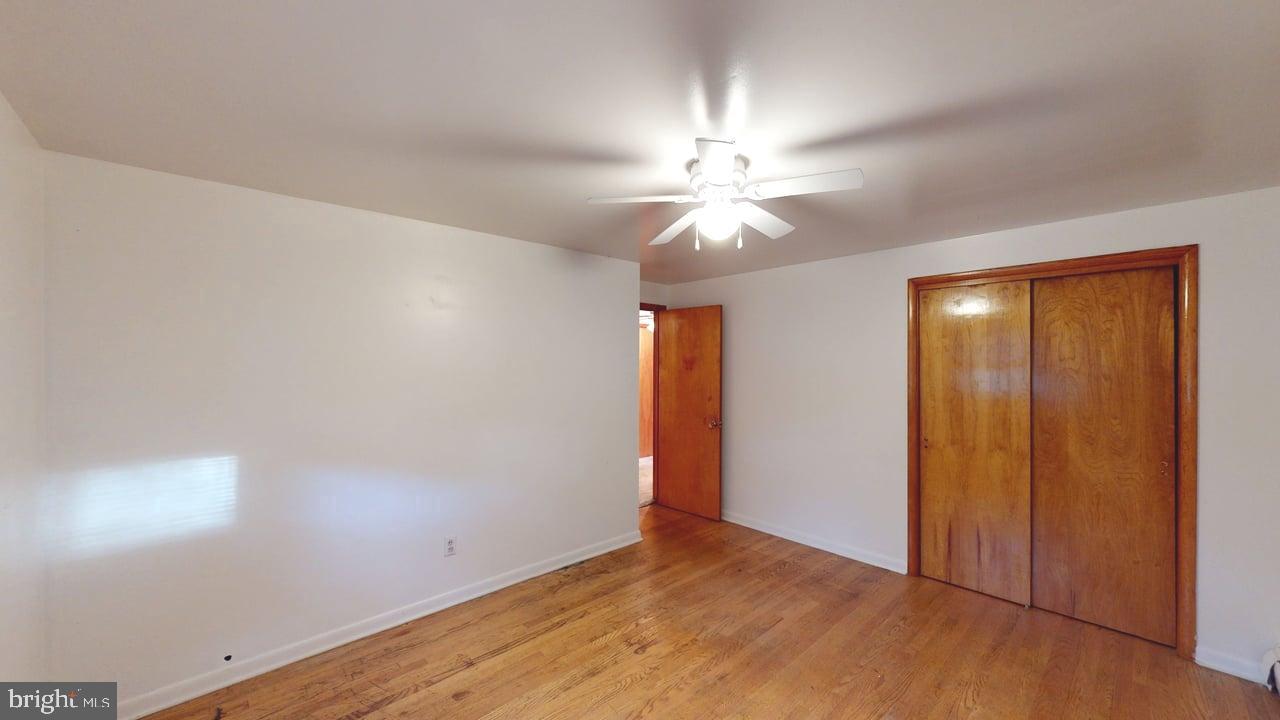 4549 Georges Run Road Ridgeley, WV 26753 - Photo 31 of 48 an empty room with a chandelier fan and wooden floor