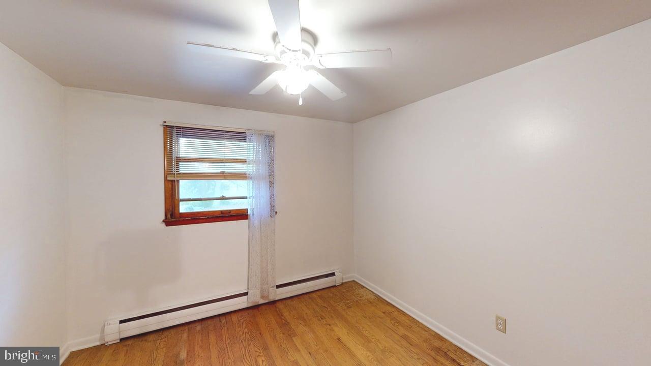 4549 Georges Run Road Ridgeley, WV 26753 - Photo 33 of 48 an empty room with a chandelier fan and windows